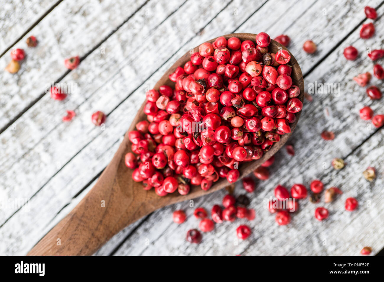 Dried pink peppercorn in spoon. Stock Photo