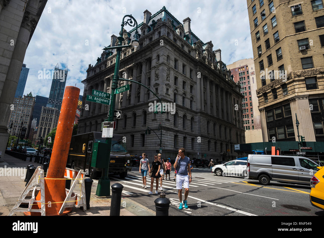 New York City, USA - July 27, 2018: Orange and white smoke stack steam pipe with people around in Centre Street, Manhattan,  New York City, USA Stock Photo