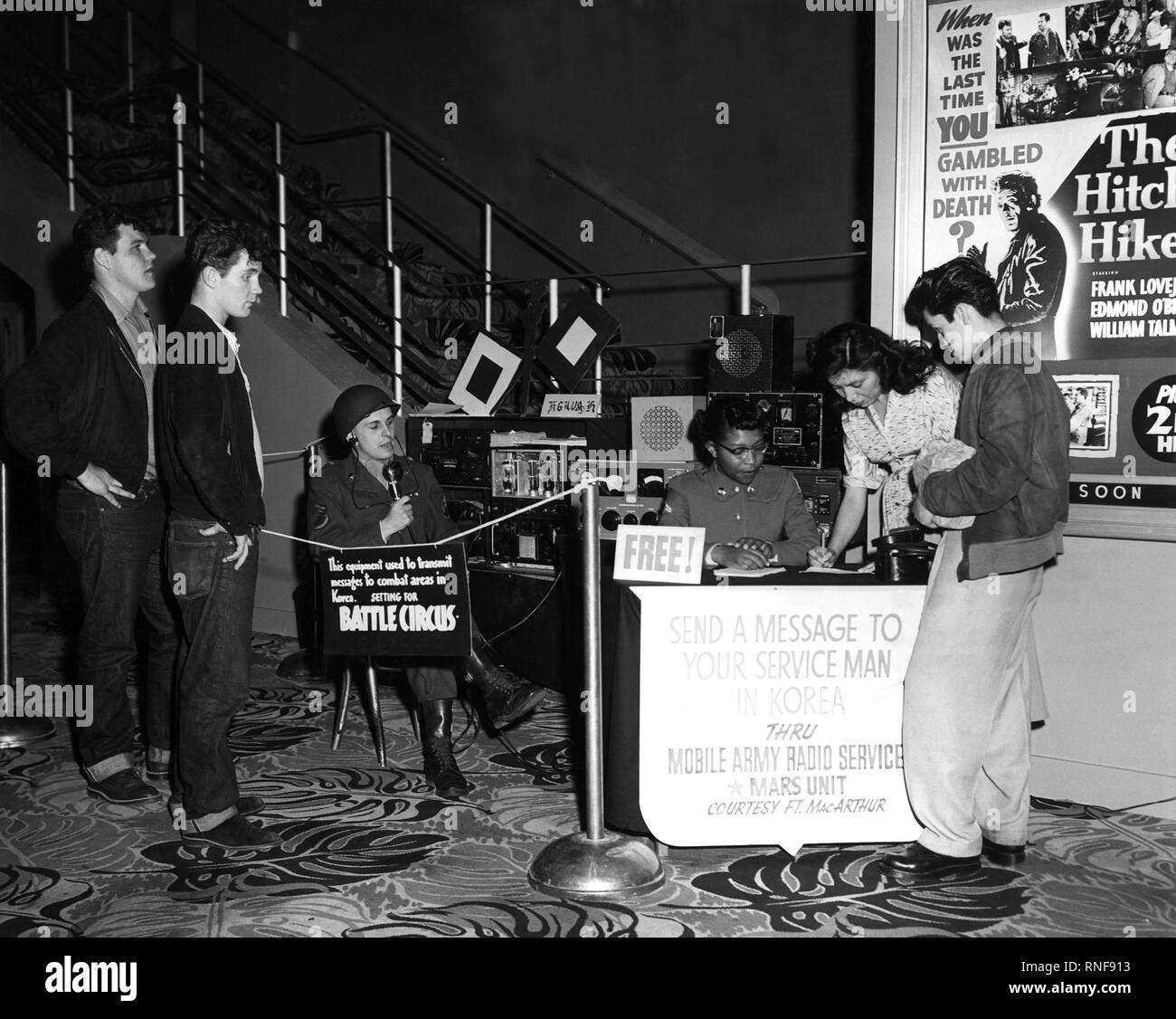 During Veteran's Day weekend in 1953, Sergeant Dieter Kaisenberg and his team from U.S. Army Radio W6USA at Fort McArthur, California set up a mobile station in the lobby of the renowned United Artist Theatre in downtown Los Angeles. Passersby were invited to give them messages that were transmitted to friends and relatives in Korea. Stock Photo