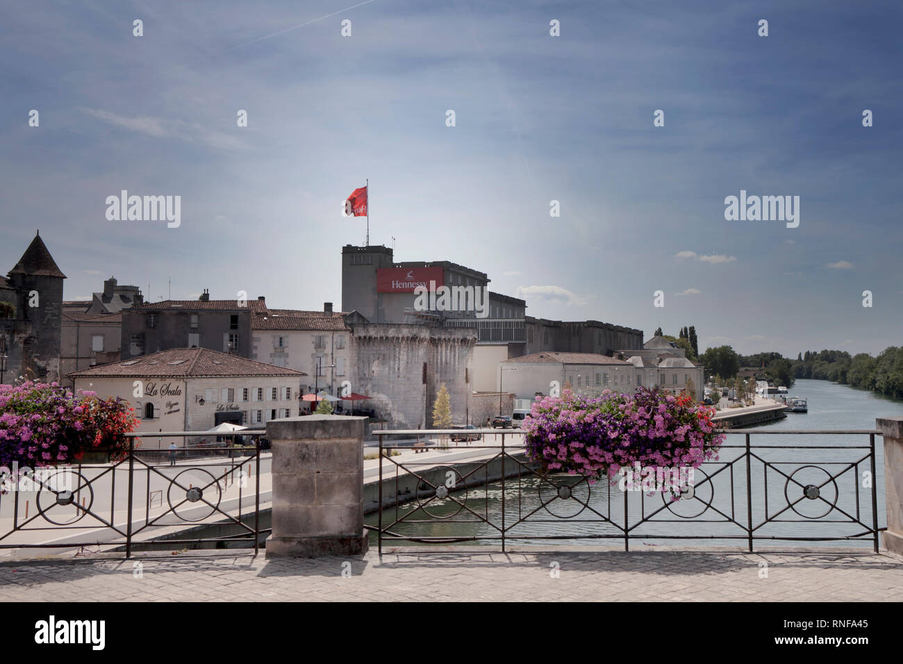 A red flag flies above Cognac house Hennessy's riverside spot in the French town of Cognac. The world's largest producer of the drink, founded in 1765 Stock Photo