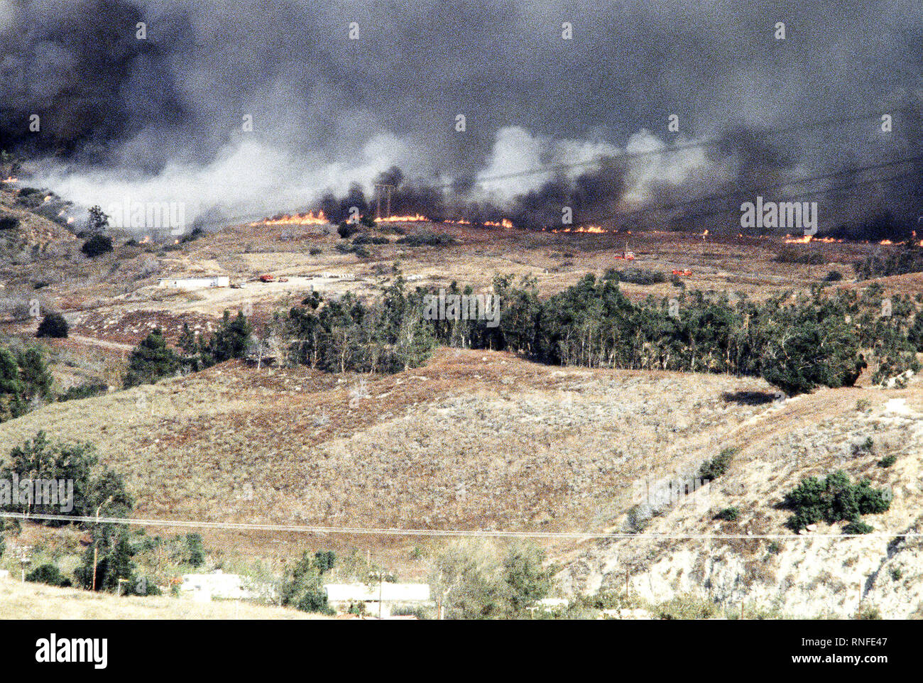 A line of fires ravage farmland during the four-day Panorama brush fire, which started in canyons north of town and has been whipped out of control by 40-50 mph winds. Stock Photo