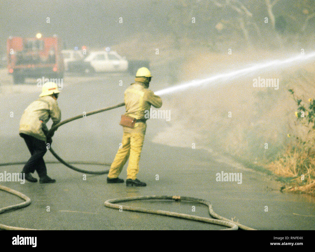 Firefighters battle fires in farmland during the four-day Panorama brush fire, which started in canyons north of town and has been whipped out of control by 40-50 mph winds. Stock Photo