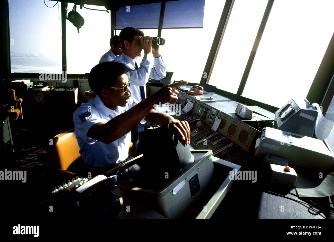 Air traffic controllers of the Air Force Communications Command (AFCC) in the control tower observe incoming and outgoing aircraft. Stock Photo