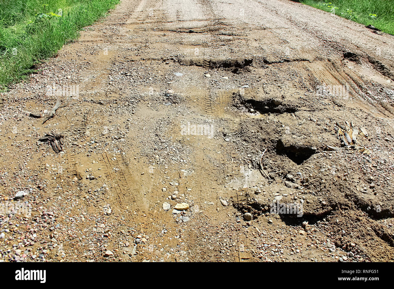 Closeup of a very bumpy washed out road Stock Photo