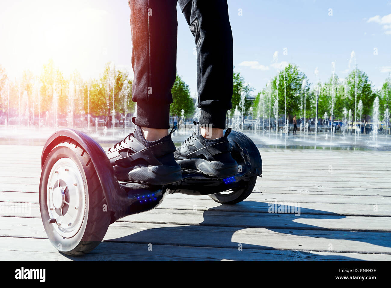 Man riding hoverboard in the park. Close Up of Dual Wheel Self Balancing  Electric Skateboard. electrical scooter outdoors. Gyroscooter Stock Photo -  Alamy