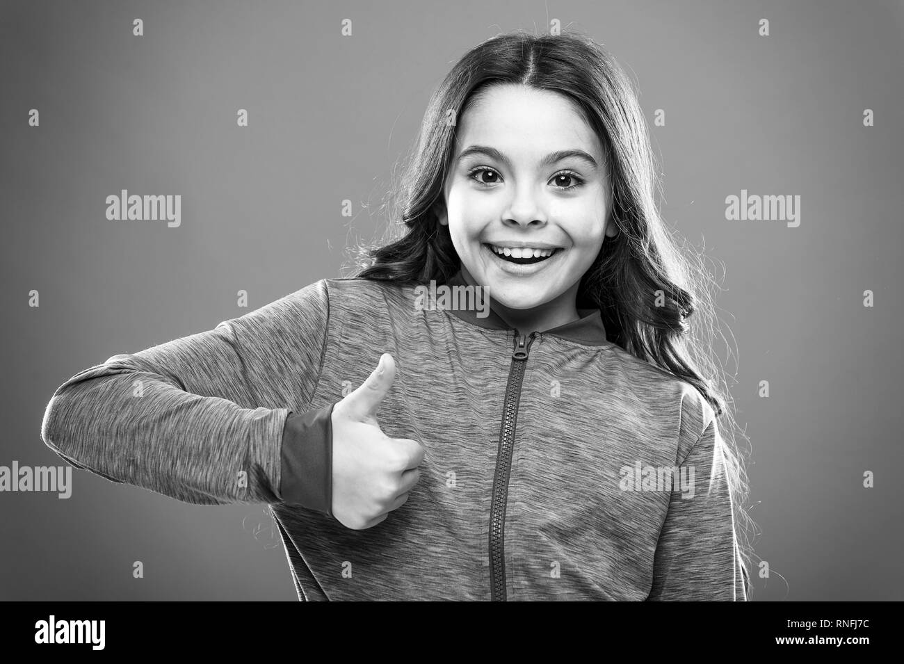 Gifts your teens will totally love. Kids actually like concept. Kid show thumb up. Girl happy totally in love fond of or highly recommend. Thumb up approvement. Girl cute child show thumbs up gesture. Stock Photo
