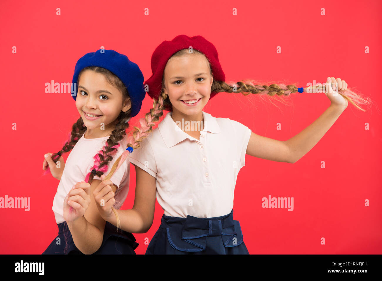 Their own style. French style girls. Cute girls having the same hairstyle. Small children with long hair plaits. Fashion girls with tied hair into braids. Little kids wearing stylish french berets Stock Their own style. French style girls. Cute girls having the same hairstyle. Small children with long hair plaits. Fashion girls with tied hair into braids. Little kids wearing stylish french berets Stock