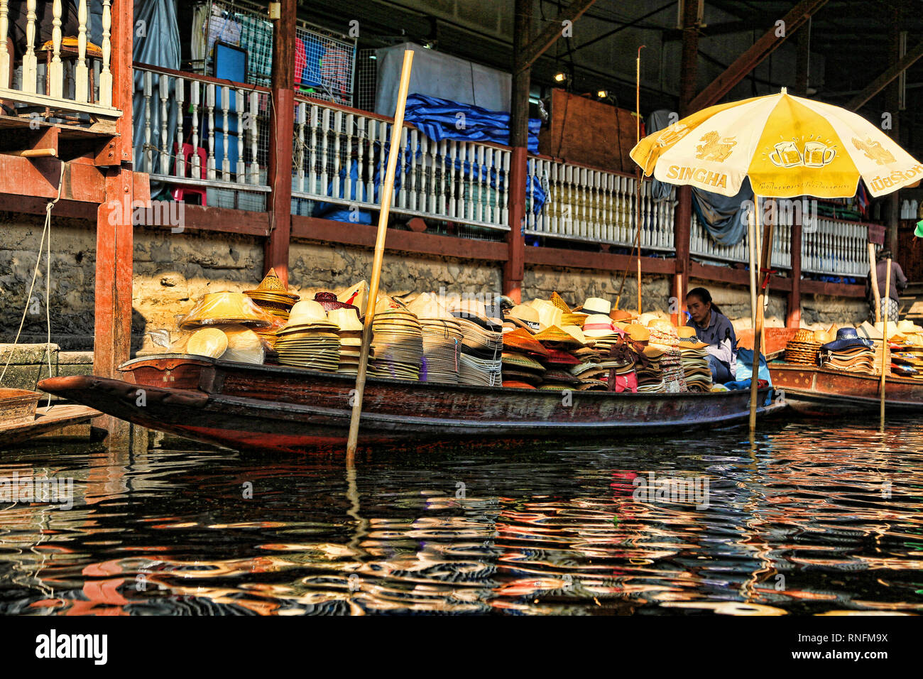 Bangkok Thailand - December 2016: Boats on canal selling hats for tourists in Damnoen Saduak floating market. Stock Photo