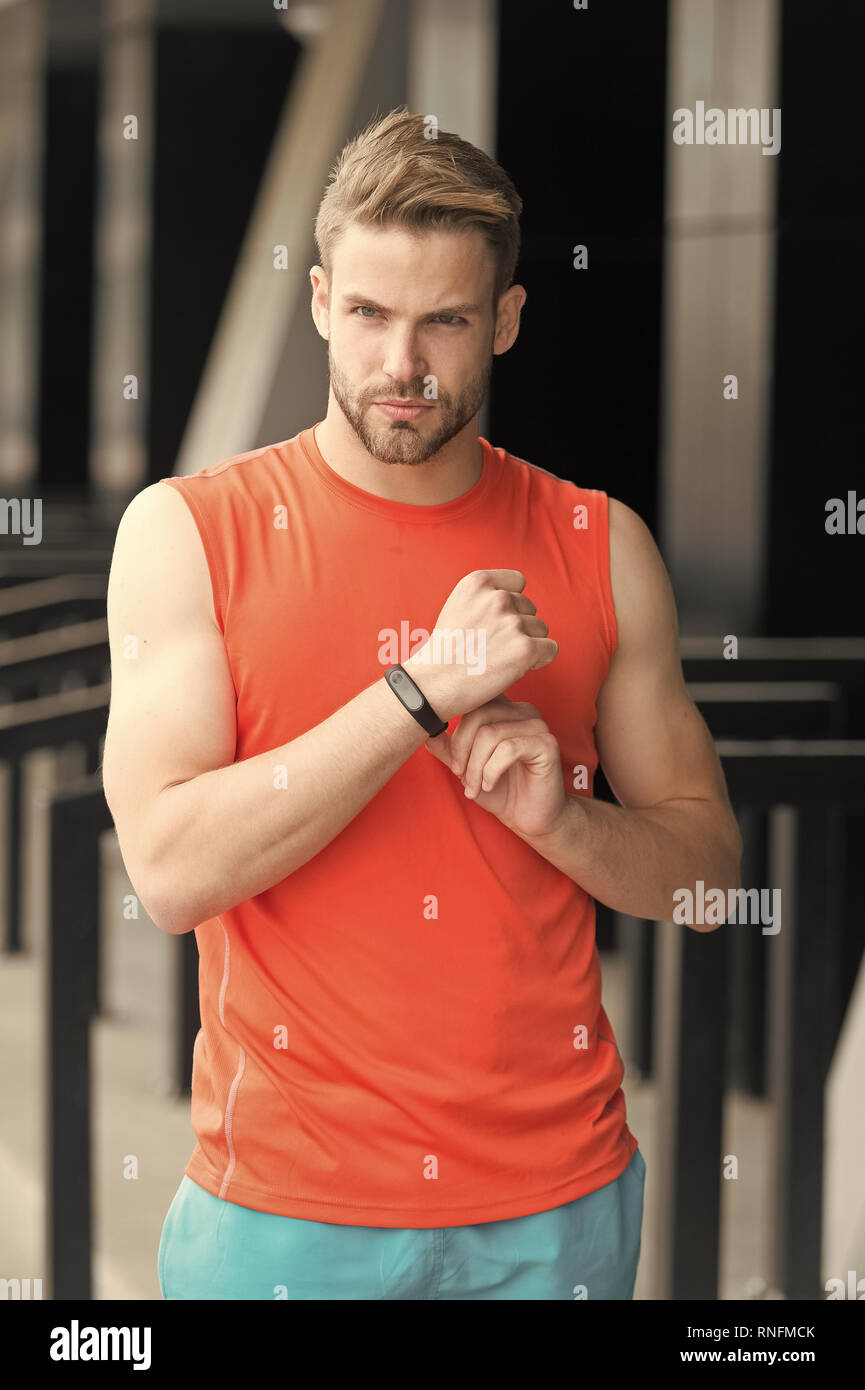 Sportsman training with pedometer gadget at stadium. Sport gadget ...