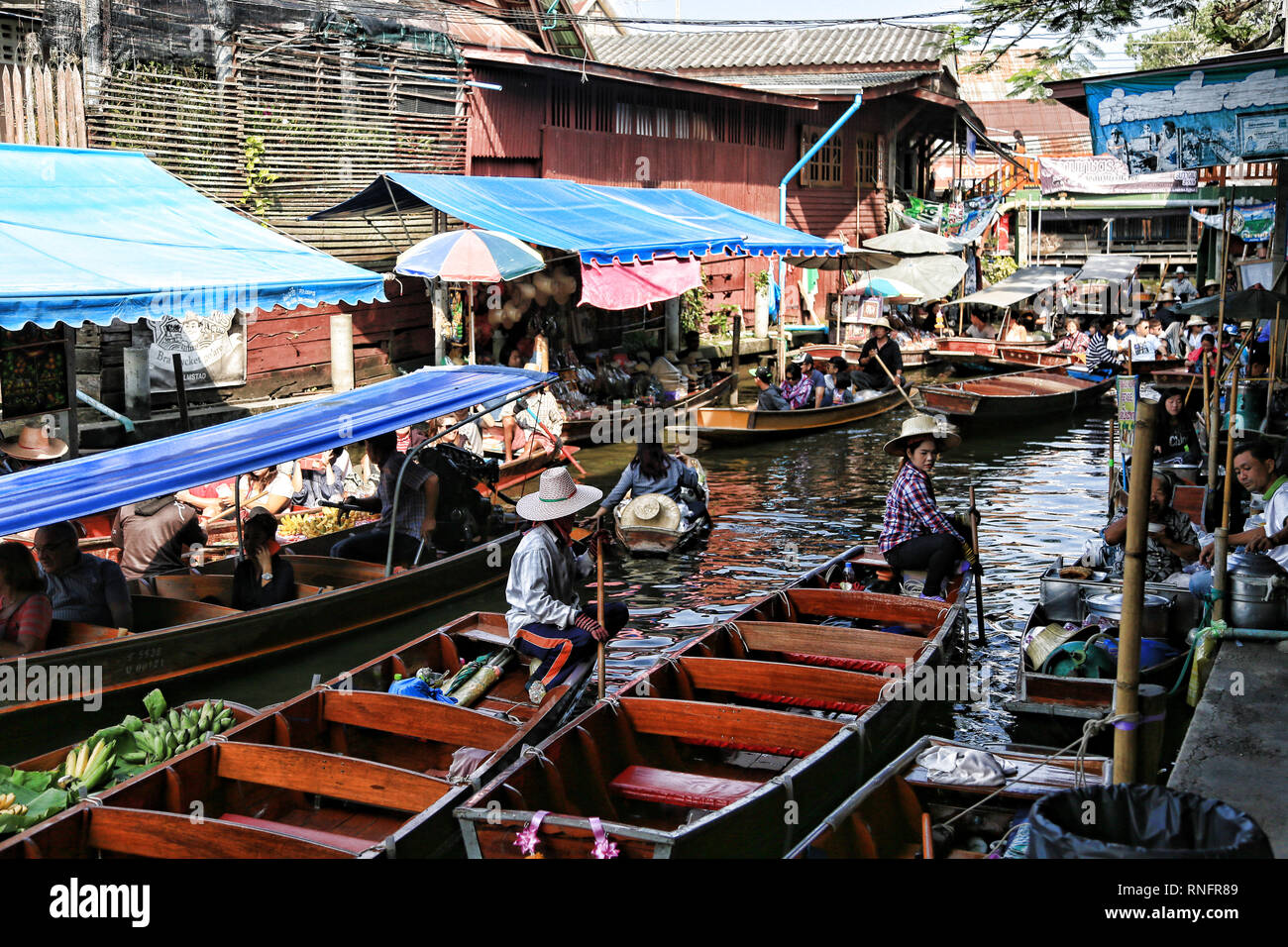 Bangkok Thailand - December 2016: Boats on canal selling fruits, foods for tourists in Damnoen Saduak floating market. Stock Photo