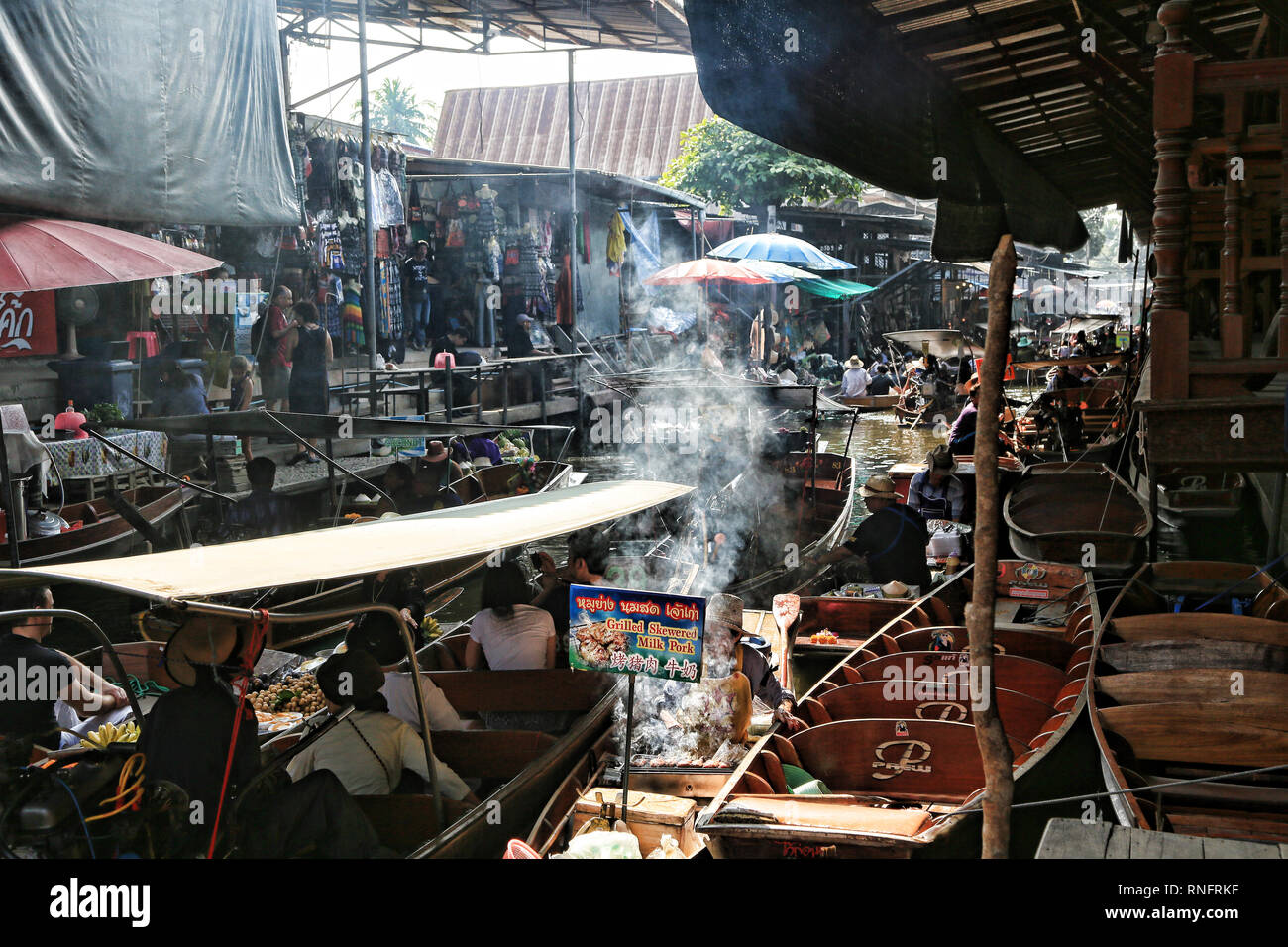 Bangkok Thailand - December 2016: Boats on canal selling fruits, foods for tourists in Damnoen Saduak floating market. Stock Photo