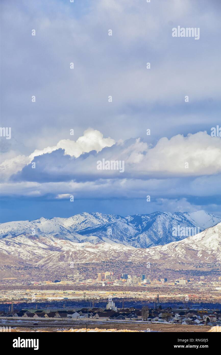 Winter Panoramic view of Snow capped Wasatch Front Rocky Mountains, Great Salt Lake Valley and Cloudscape from the Bacchus Highway. Utah, USA. Stock Photo