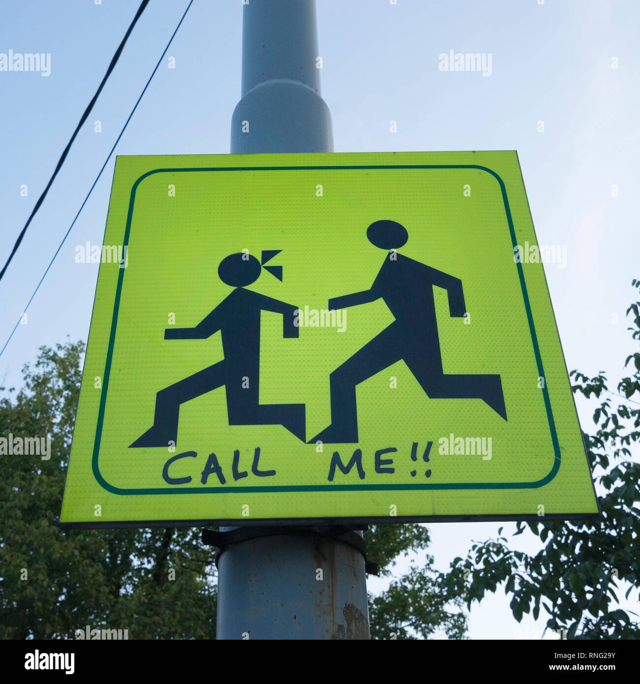 Call Me words added to the bottom of a crosswalk sign in Belgrade, Serbia. Stock Photo