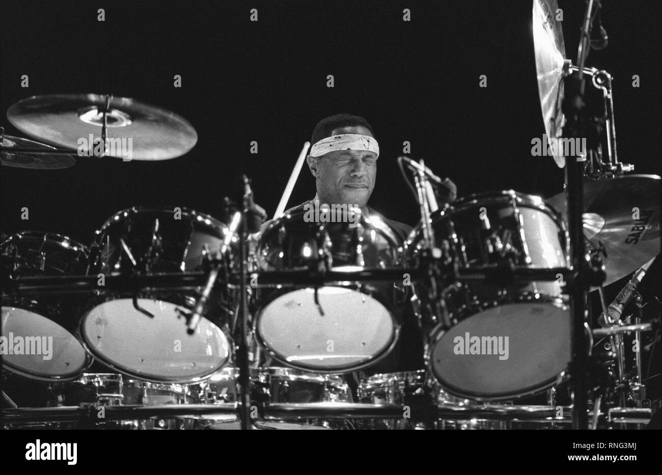 Drummer Billy Cobham is shown performing on stage during a "live