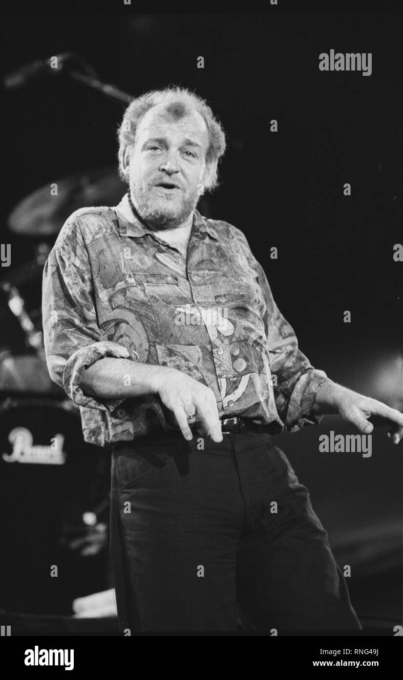 Singer Joe Cocker is shown performing on stage during a "live" concert