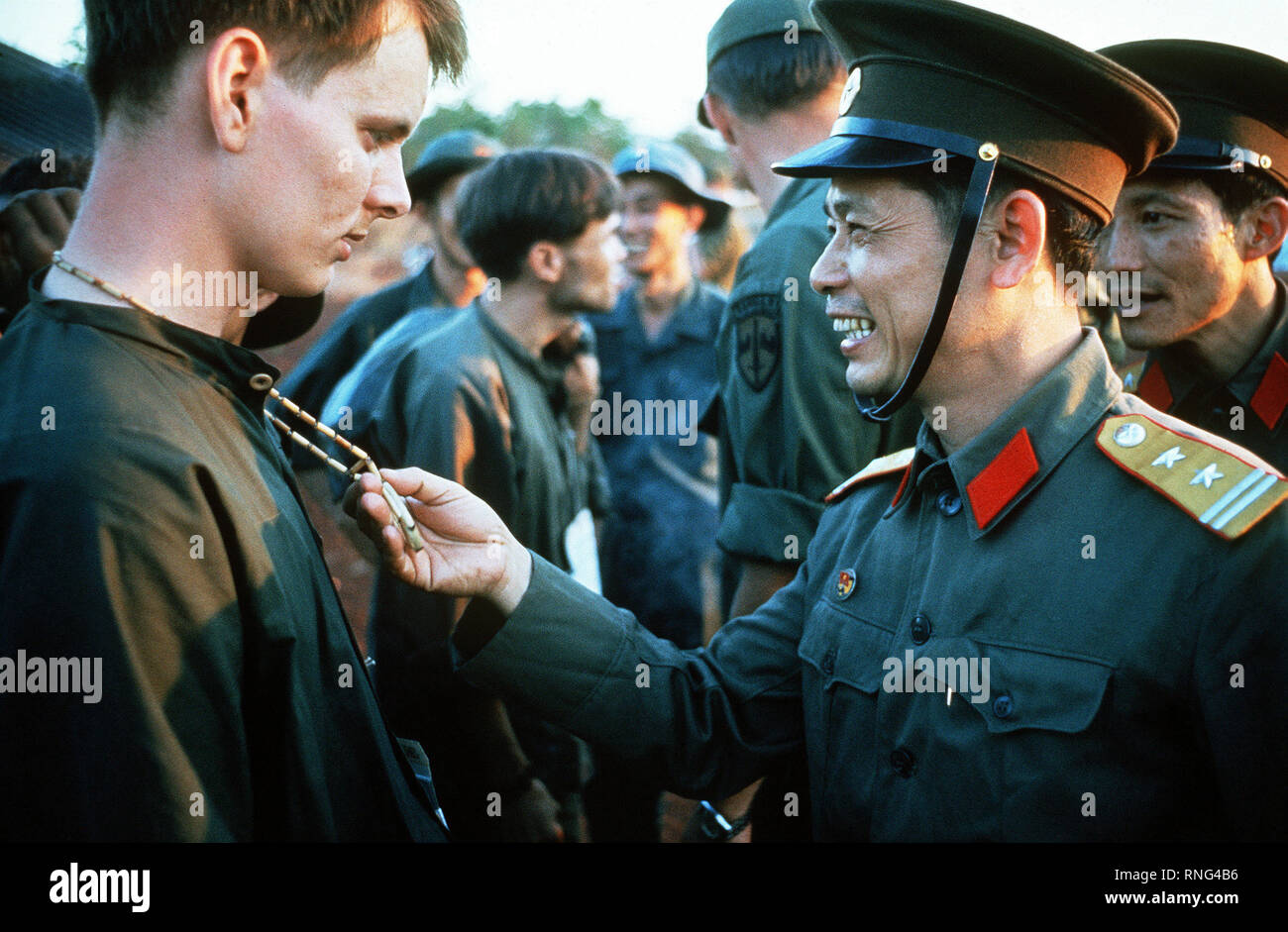 SPC-4 Richard Springman, U.S. Army, Captured 25 May 70) talks with a North Vietnamese Army officer who is looking at his peace symbol.  He is one of the twenty eight American POWs who were released by the Viet Cong on Feruary 12, 1973. Stock Photo
