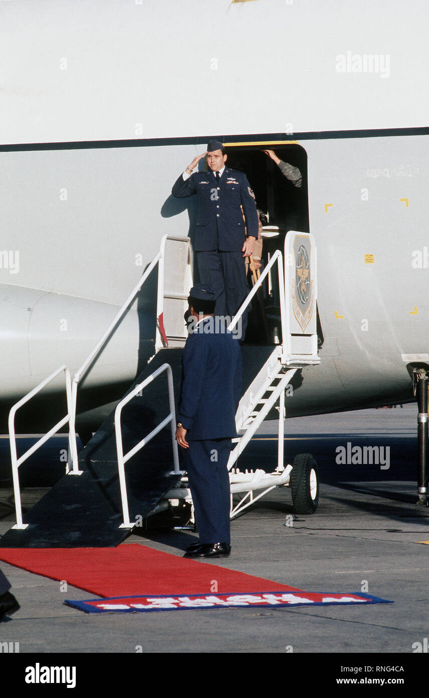 Former POW and U.S. Air Force MSGT William Andrew Robinson (Captured 20 Sep 65) salutes the colors upon his arrival on the C-141 Starlifter from Clark Air Base, Philippines.  MSGT Robinson was in the first group of POWs released on 12 Feb 73 by the North Vietnamese government in Hanoi. Stock Photo