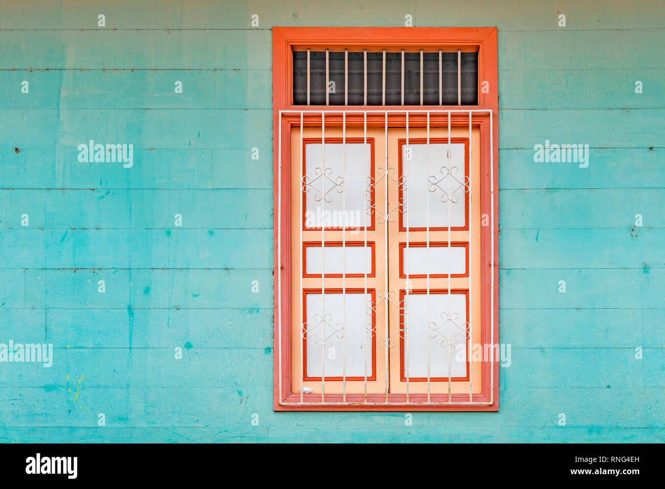 Architecture detail of a window with a turquoise wood wall in the district of Las Penas on the Santa Ana hill in Guayaquil, Ecuador. Stock Photo