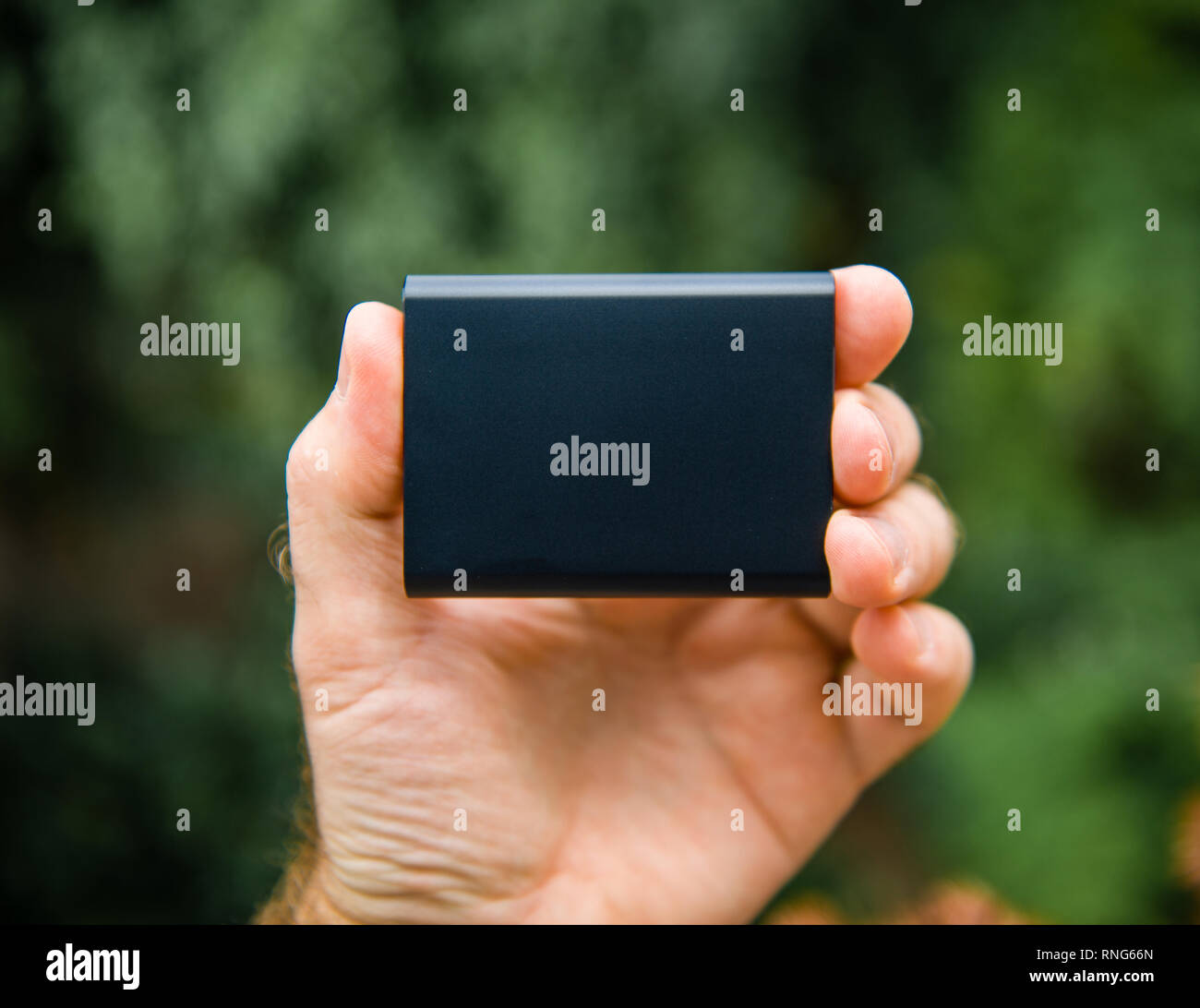 Man hand holding Portable SSD 2 tb external hard drive disk with high read  and write speed against green background unboxing testing Stock Photo -  Alamy