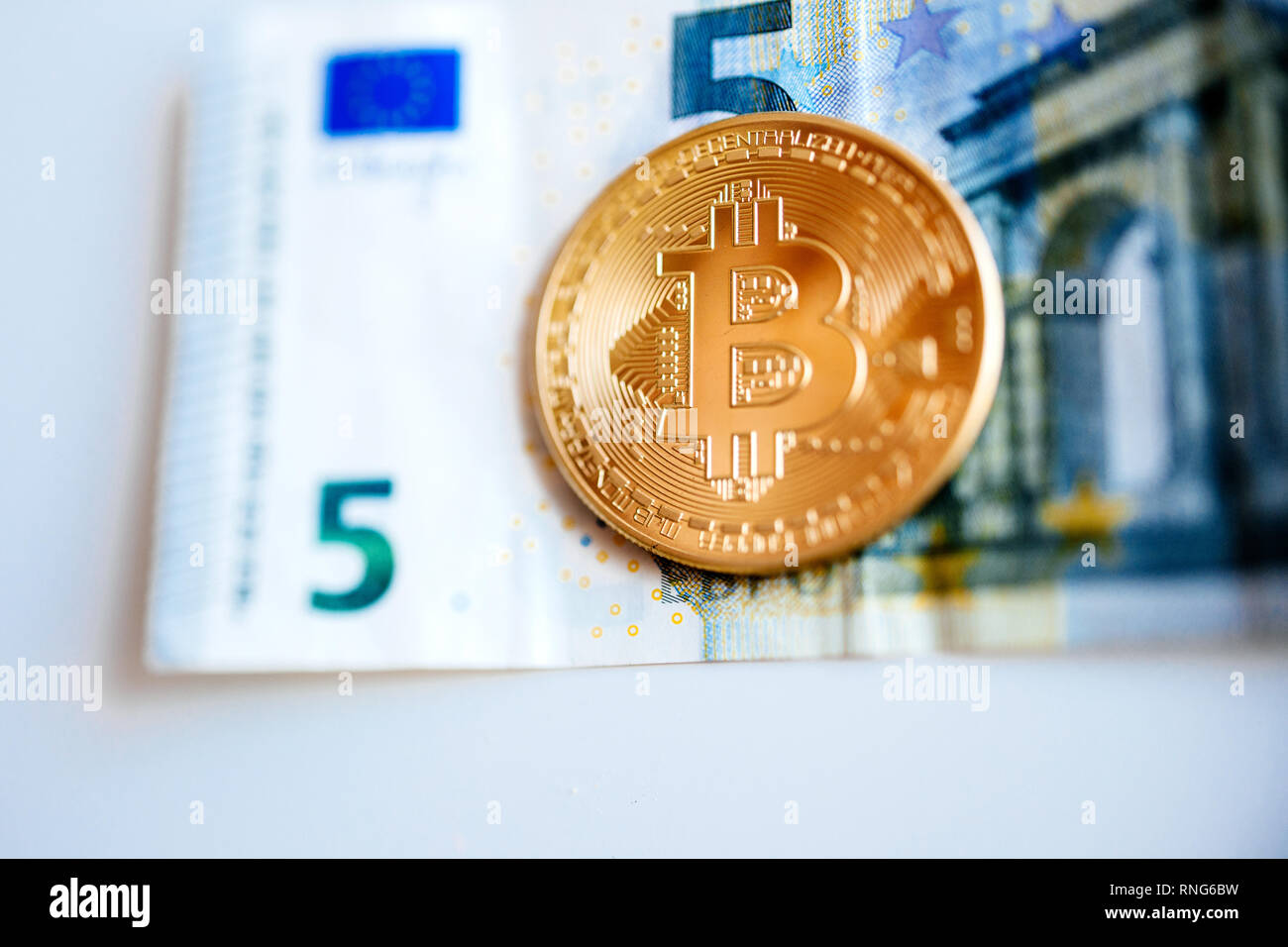 Macro view of a bitcoin with a euro banknote as background , concept of  crypto currency in Spain Stock Photo - Alamy