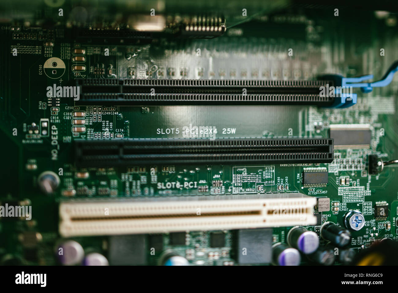 Multiple PCI and PCIE computer slots on a powerful motherboard in modern server workstation Stock Photo