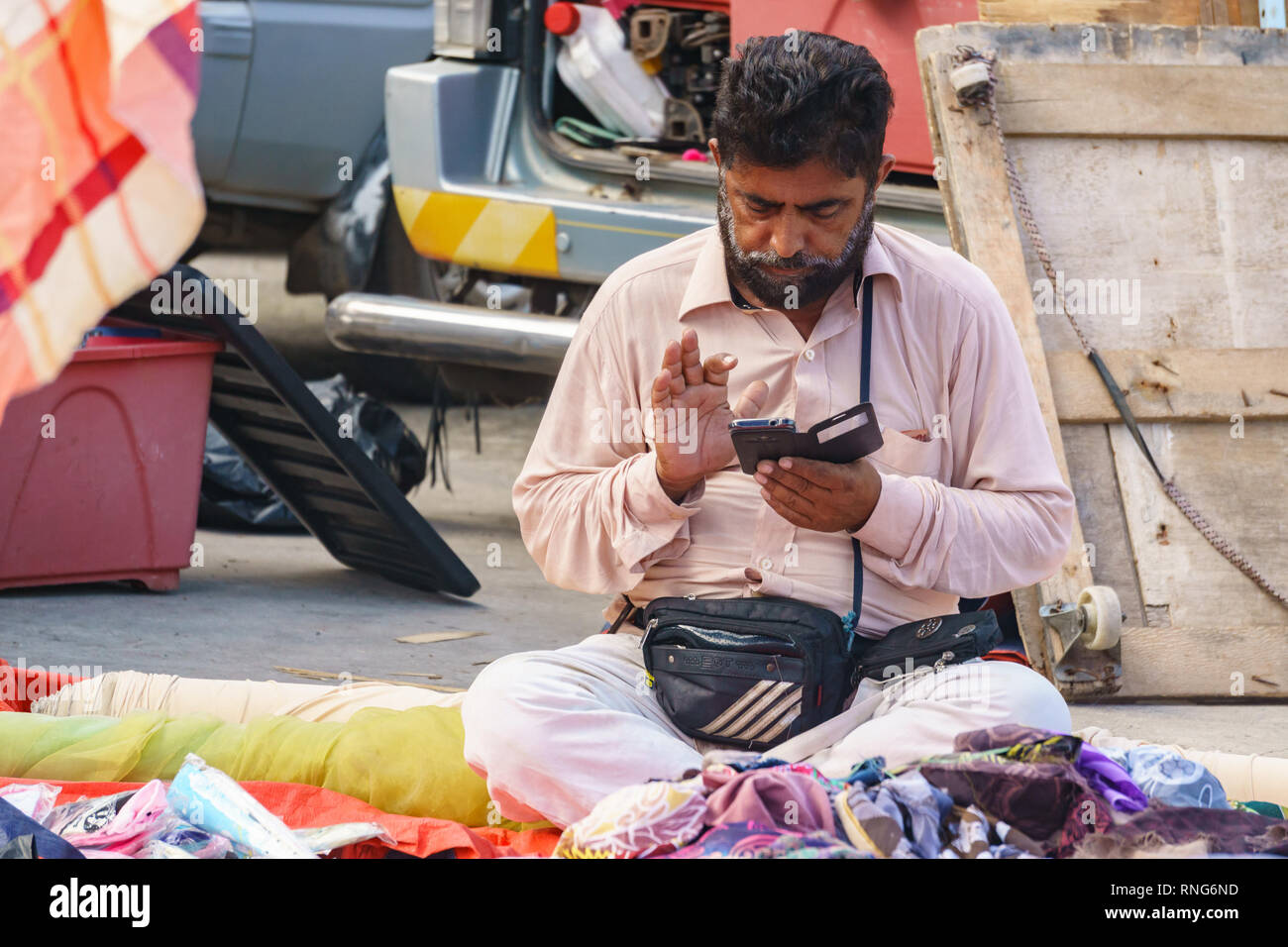 Kiulu Sabah Malaysia-August 30, 2016 : An identified man using smartphone at open market area. Smartphone is an everyday gadget among Malaysian. Stock Photo