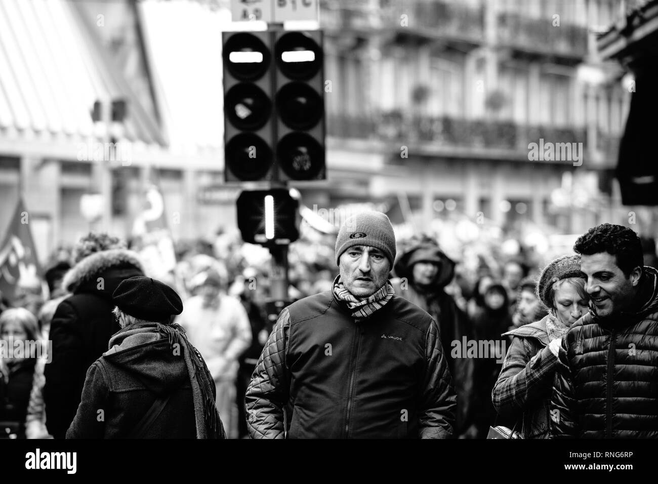 STRASBOURG, FRANCE - MAR 22, 2018: CGT General Confederation of Labour workers with placard at demonstration protest against Macron French government string of reforms - black and white image of adult man in front of protesters Stock Photo