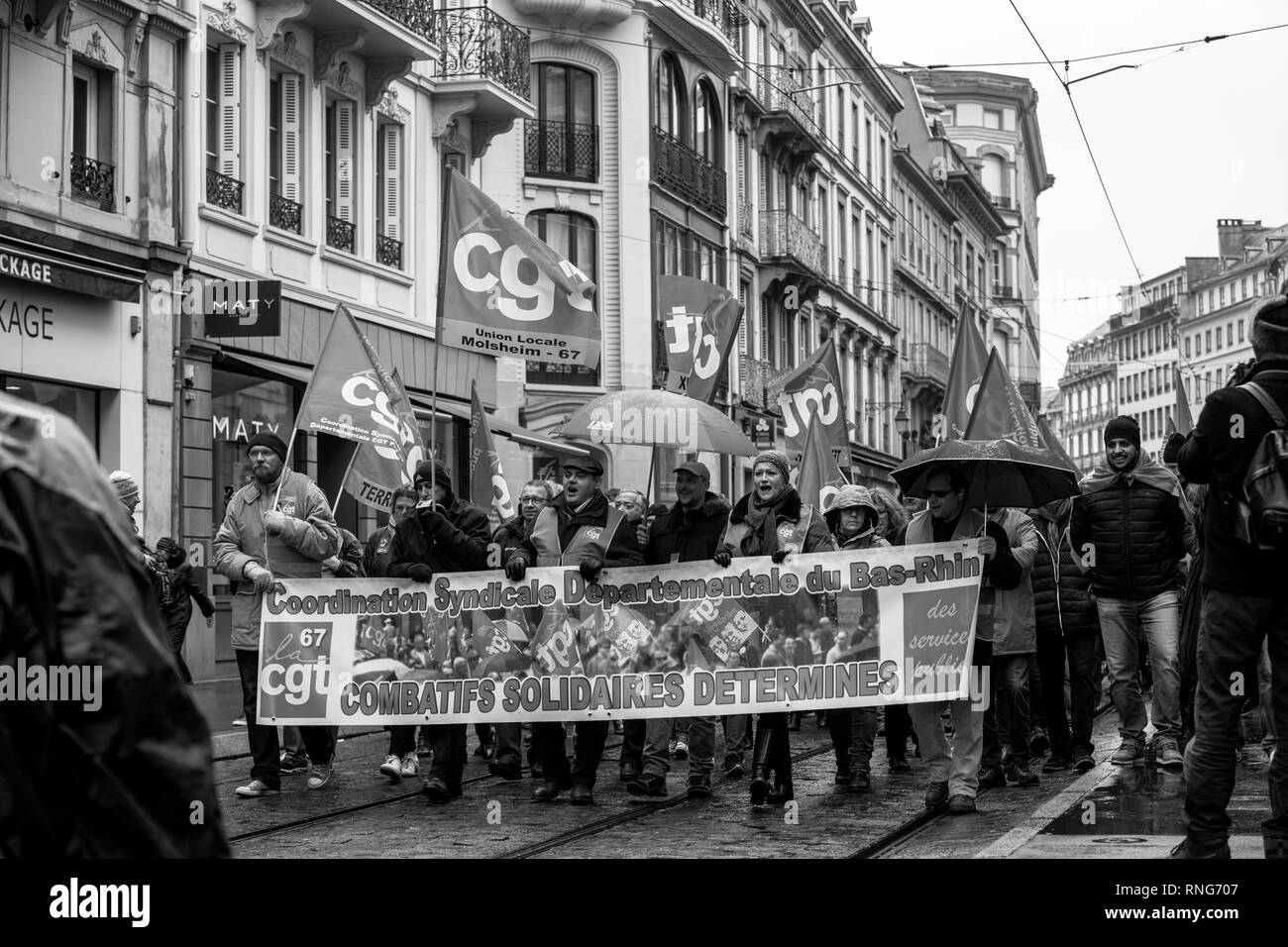 STRASBOURG, FRANCE - MAR 22, 2018: CGT General Confederation of Labour workers with placard at demonstration protest against Macron French government string of reforms - people with large banner combatif solidaires determines Stock Photo