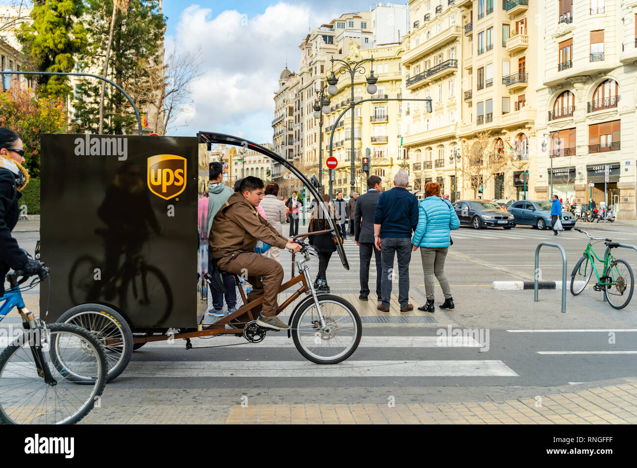 Valencia,Spain - February 18, 2019: UPS worker on the bicycle. Non  contaminating vehicle, corrier Stock Photo - Alamy