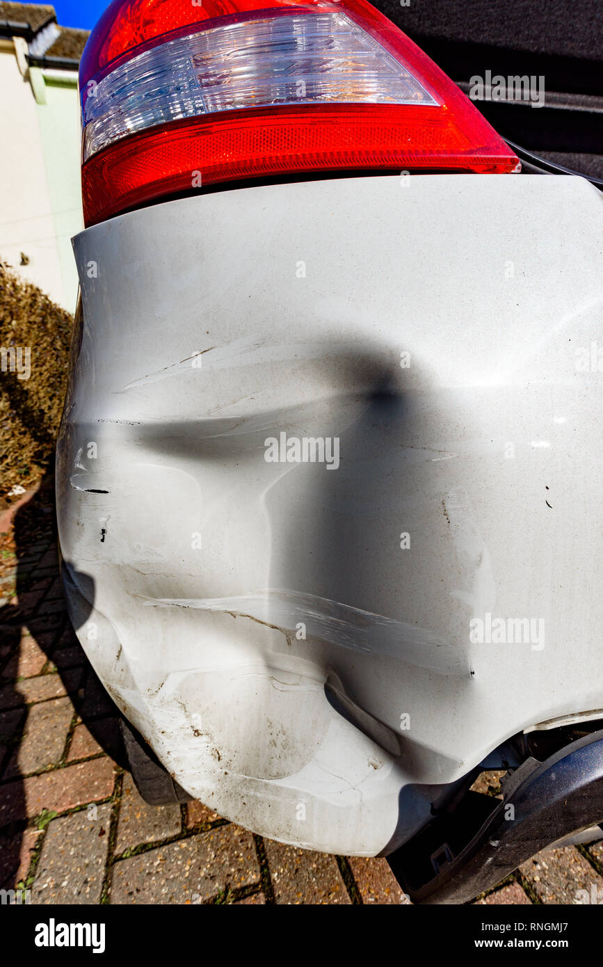 Car Crash and Car Damage; White vehicle rear bumper damage. Stock Photo