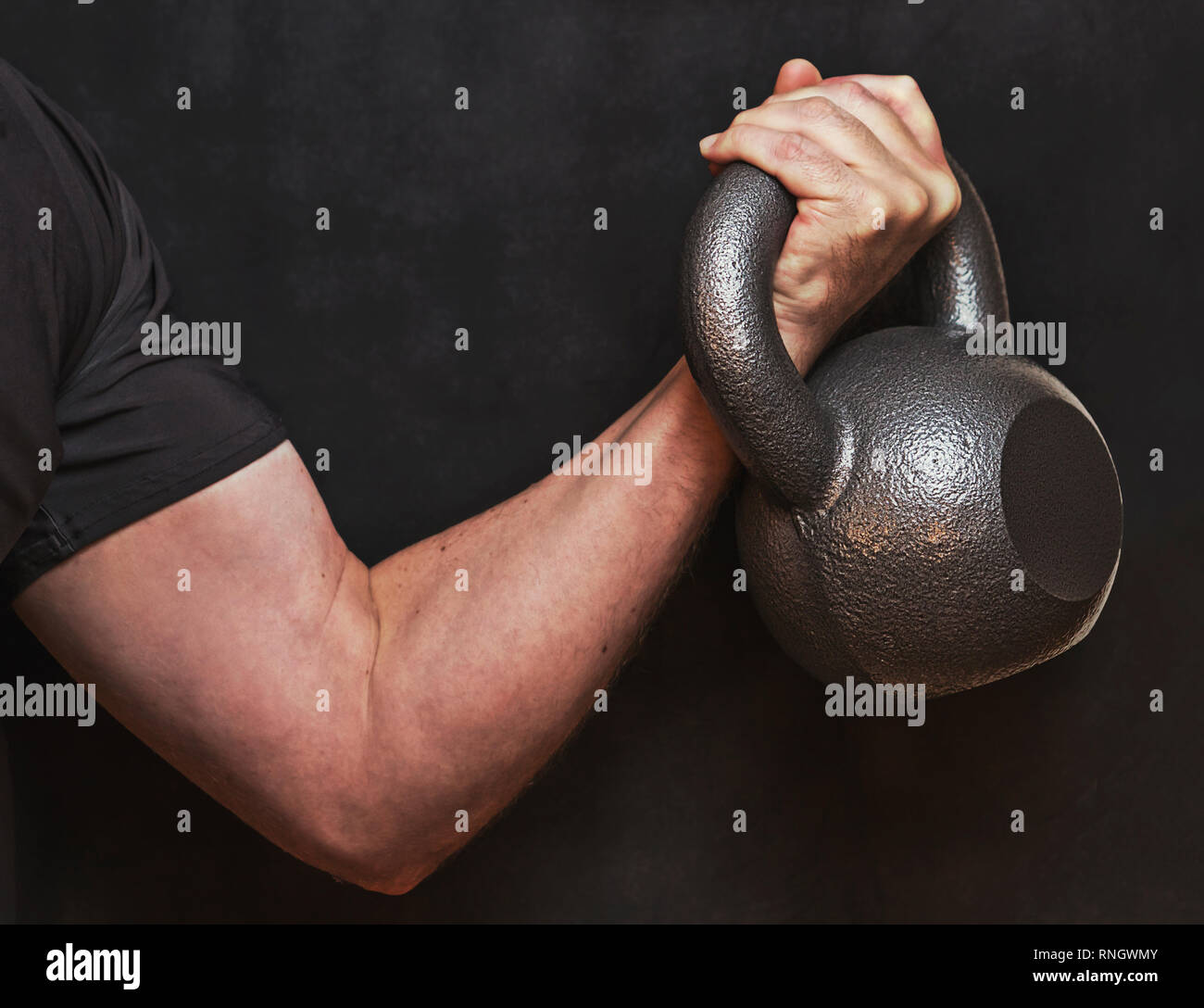 Kettlebell bicep curl, closeup of arm and hand working out with weights.  Dark dramatic exercise photo for inspiration fitness over 40 Stock Photo -  Alamy