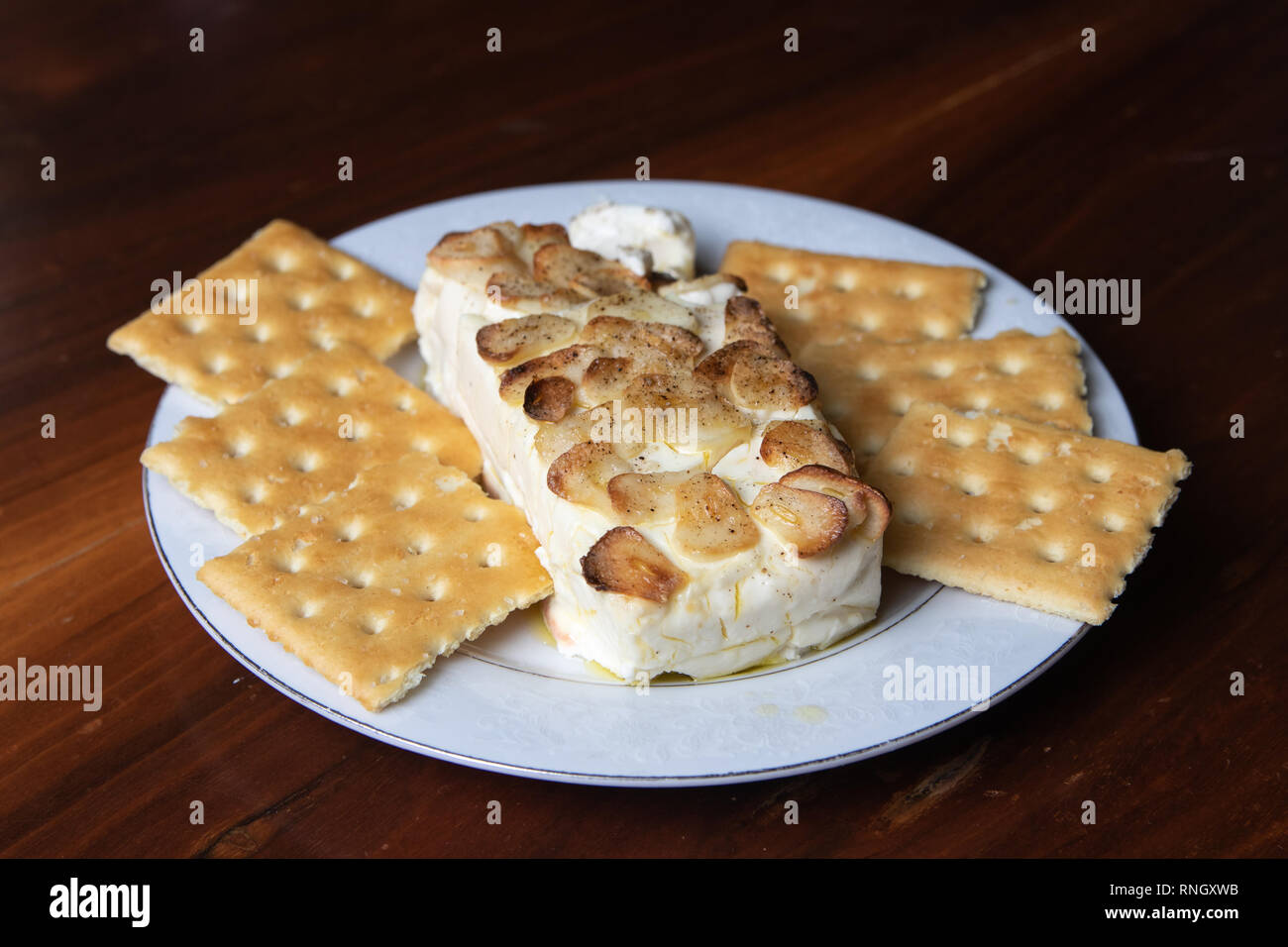 delicious garlic and cheese dip and cookies with wooden background Stock Photo