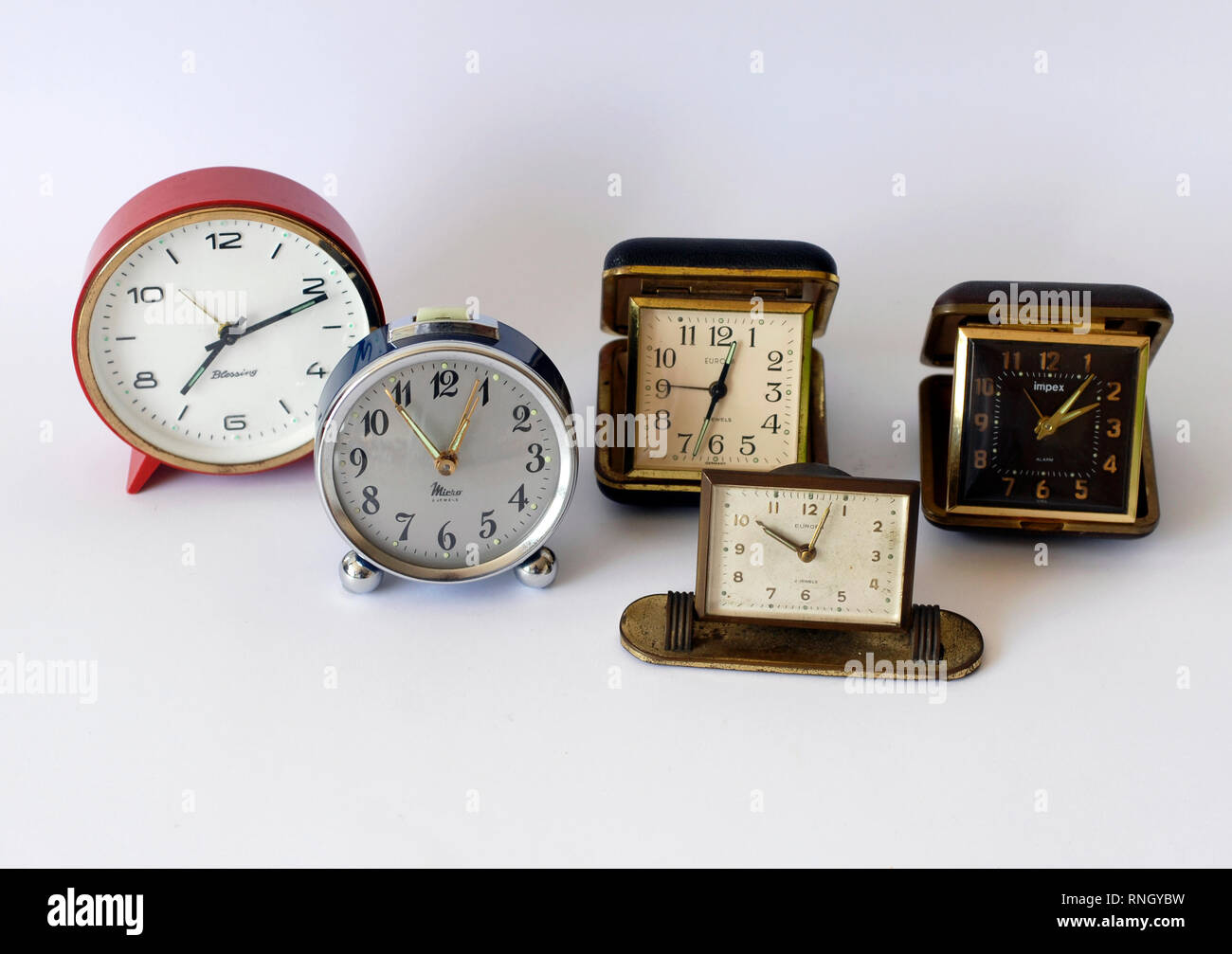 Five vintage wind-up clocks. Europe Jewels, Germany; Impex, Korea; Europe Jewels, Germany; Micro, Spain; Blessing, West Germany Stock Photo