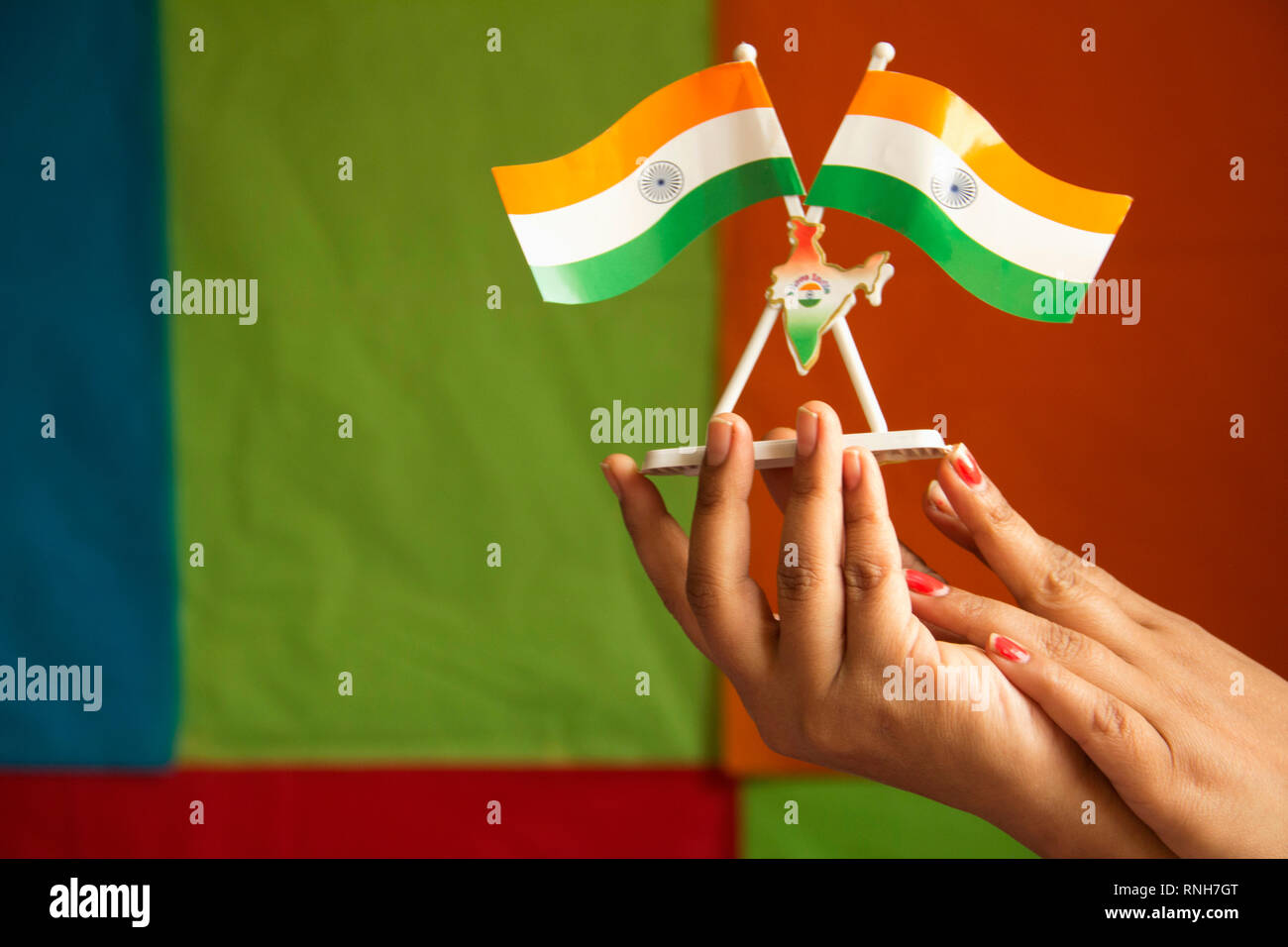 Close-up of woman's hand holding Indian flag table stand or car stand Stock Photo
