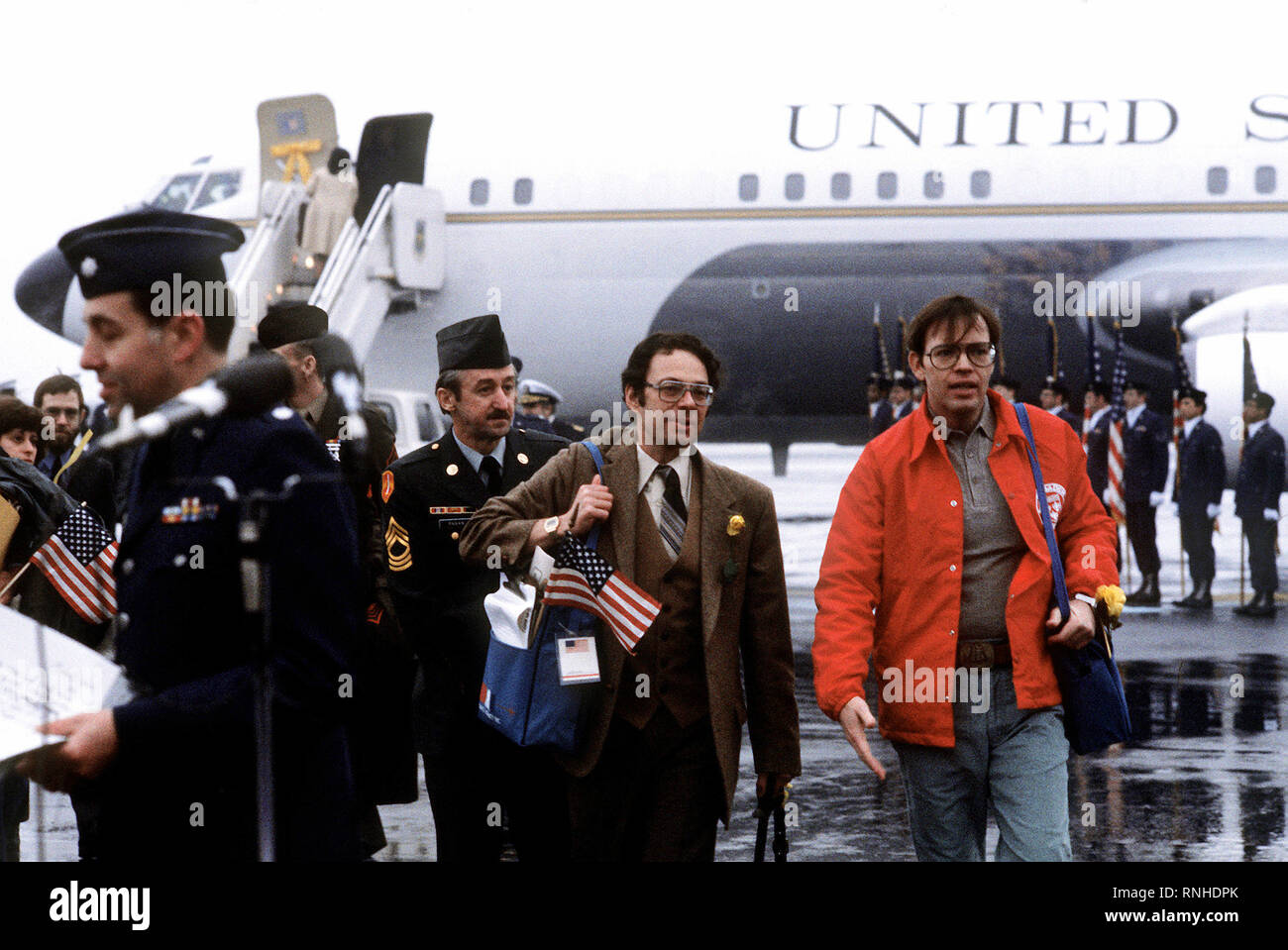 1981 - Former hostages Army MSGT Regis Ragan, Sharerand and Clair Barnes, left to right, arrive at the base for their departure to the United States.  The 52 hostages were hospitalized for a few days after their release from Iran Stock Photo