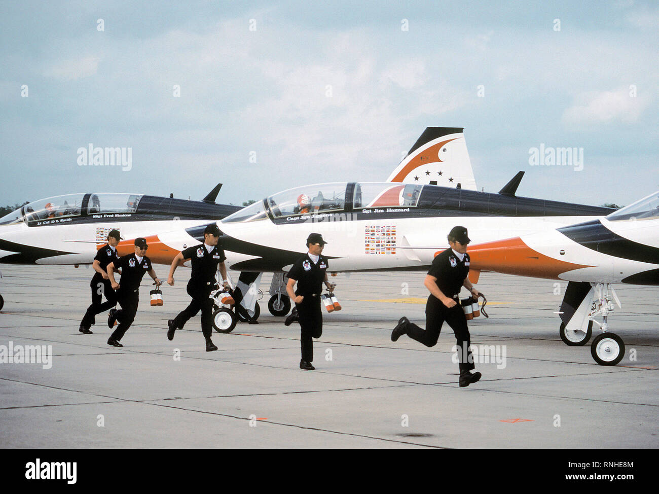 1980 - Crew chiefs of the Thunderbirds team run to their T-38 Talon aircraft for preflight activities Stock Photo