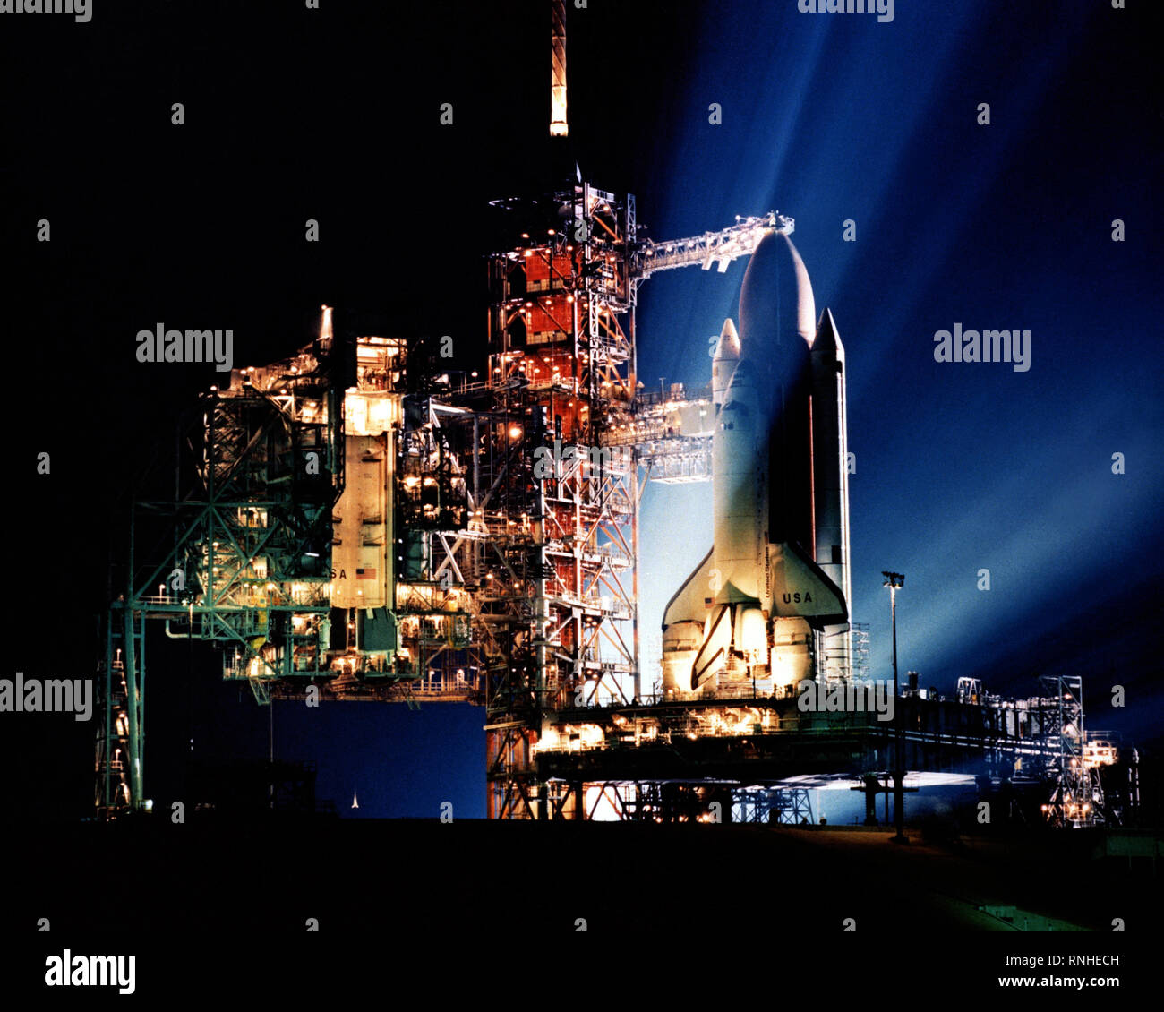 Silhouetted by searchlights directed toward it, the STS-3 Space Shuttle ...
