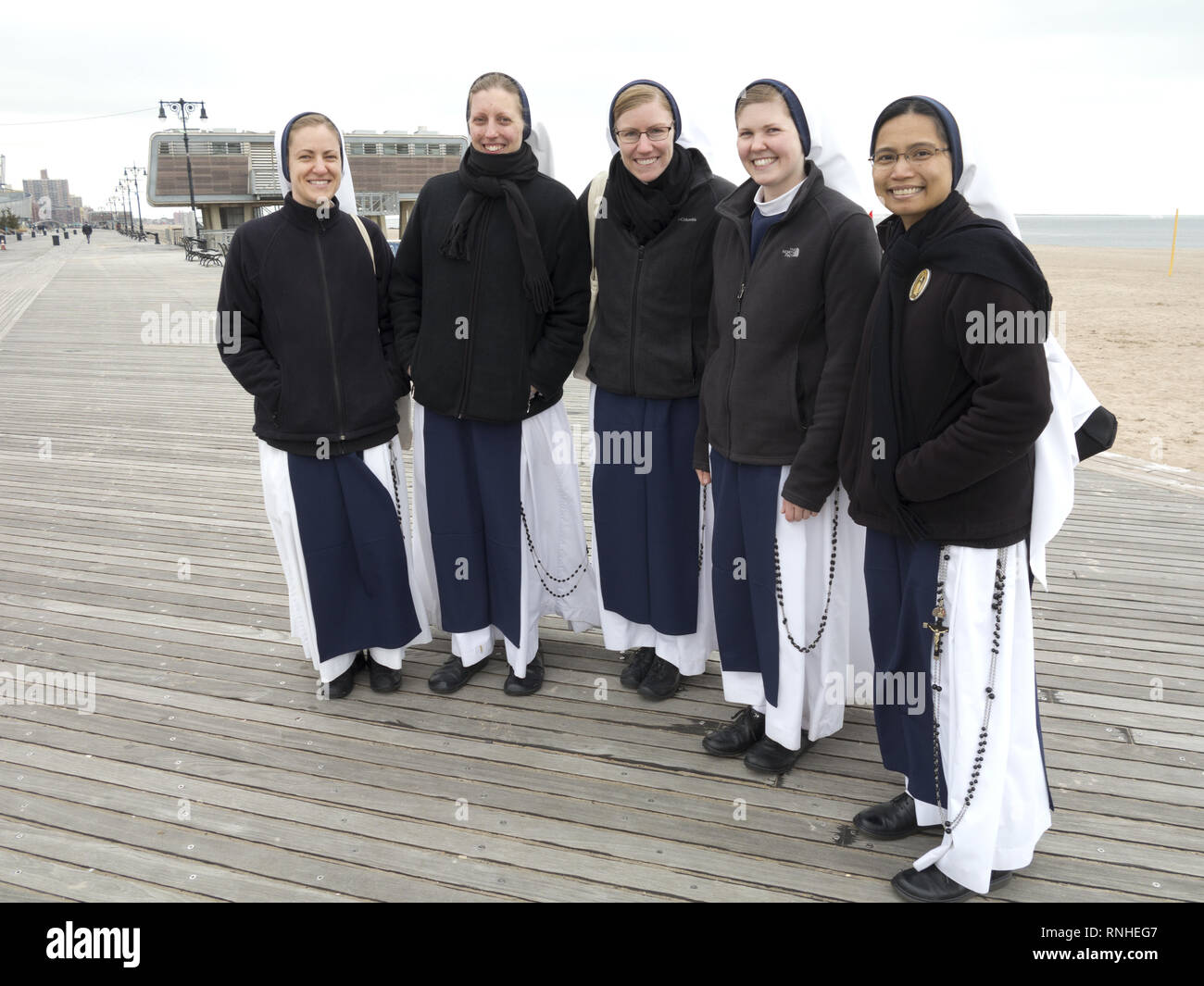 Young nuns enjoy an outing on the Coney Island boardwalk in Brooklyn, NY. Stock Photo