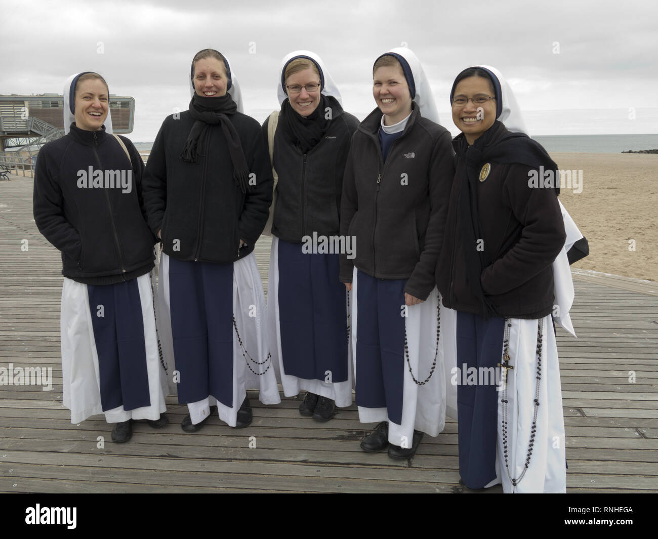 Young nuns enjoy an outing on the Coney Island boardwalk in Brooklyn, NY. Stock Photo
