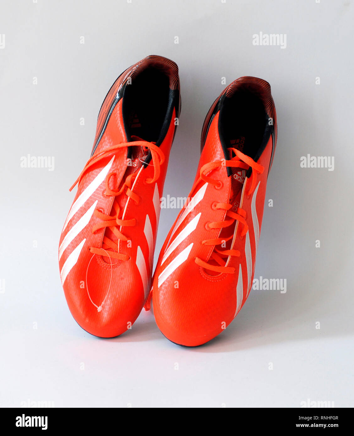 F30 football boots.Color orange infrared. natural skin, . Tacos Traxion 2.0 with three traction edges. Season 2013 2014 Stock Photo - Alamy