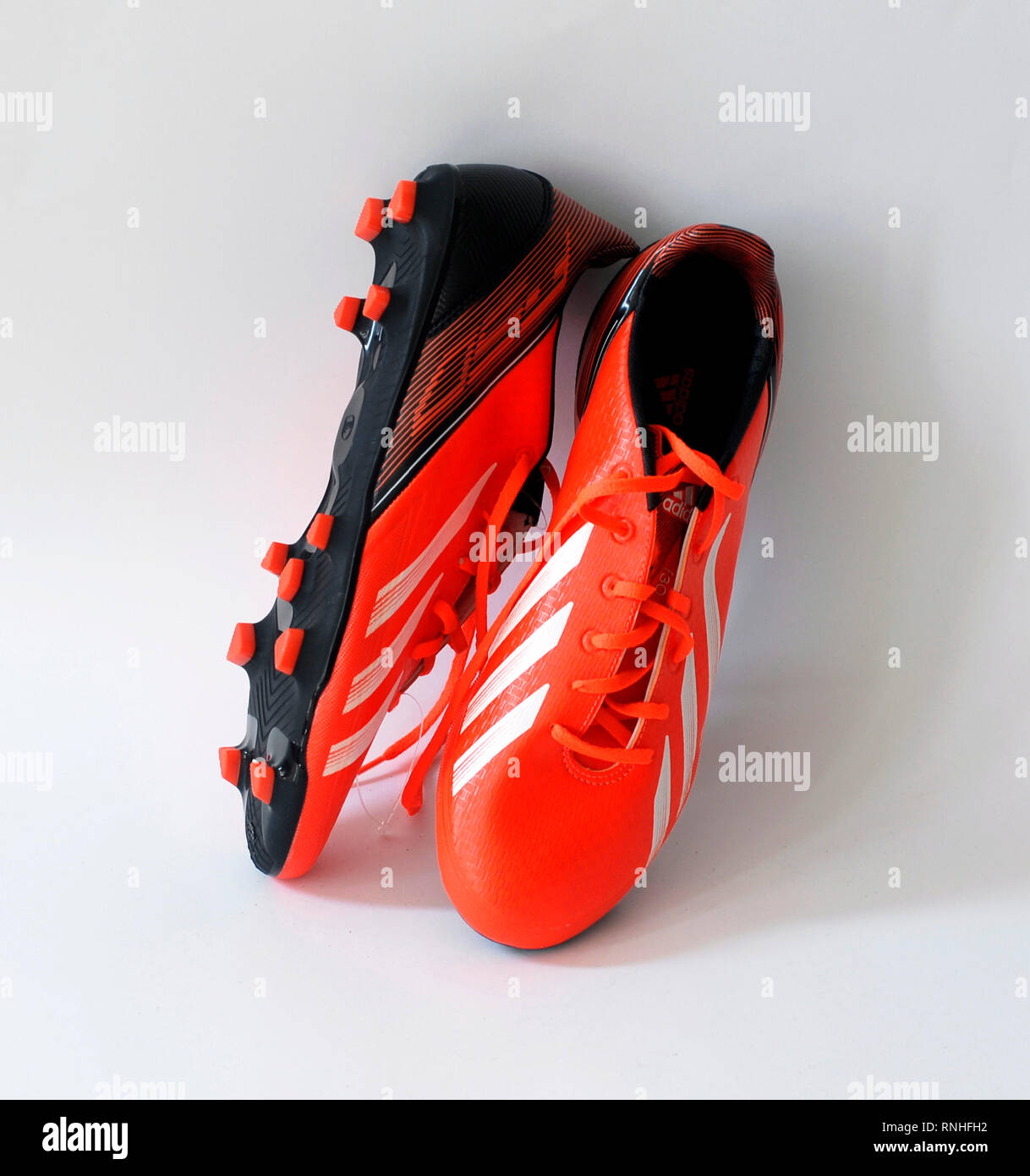 Adidas F30 football boots.Color orange infrared. Made by natural skin, .  Tacos Traxion 2.0 with three traction edges. Season 2013 - 2014 Stock Photo  - Alamy