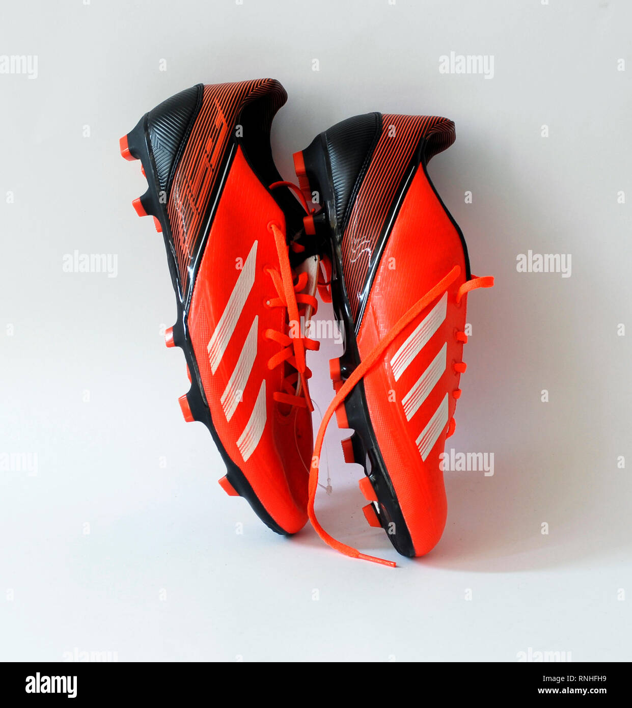 Adidas F30 football boots.Color orange infrared. Made by natural skin, . Tacos Traxion 2.0 with three traction edges. Season 2013 - 2014 Stock Photo