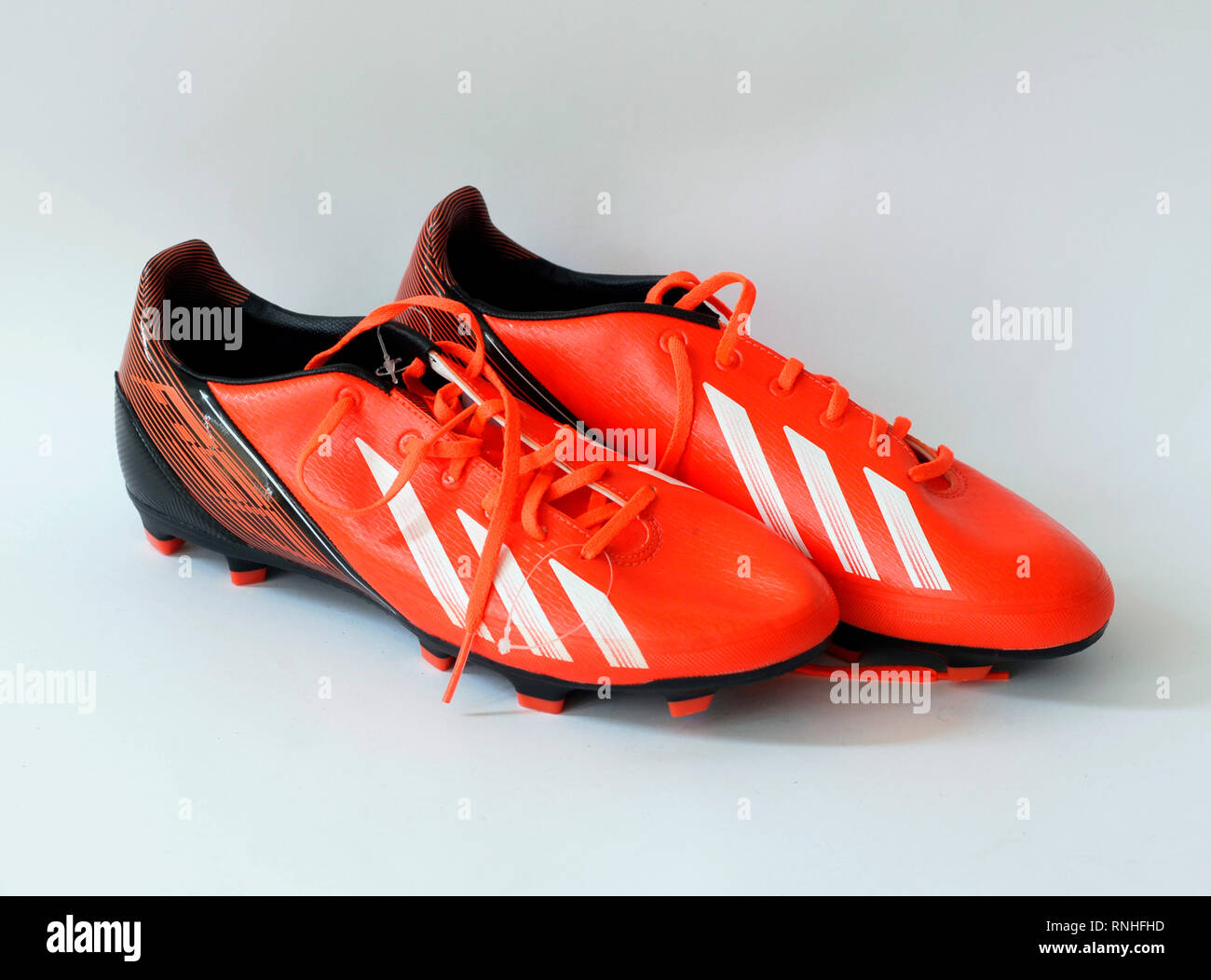F30 football boots.Color orange infrared. natural skin, . Tacos Traxion 2.0 with three traction edges. Season 2013 2014 Stock Photo - Alamy