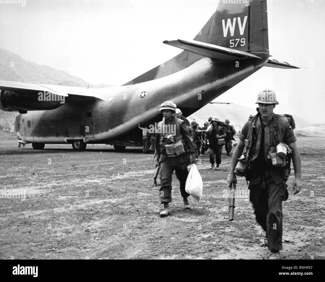 1968 - U.S. Marines head into combat after being airlifted to Calu by the C-123 Provider aircraft of the 311th Air Commando Squadron. Stock Photo