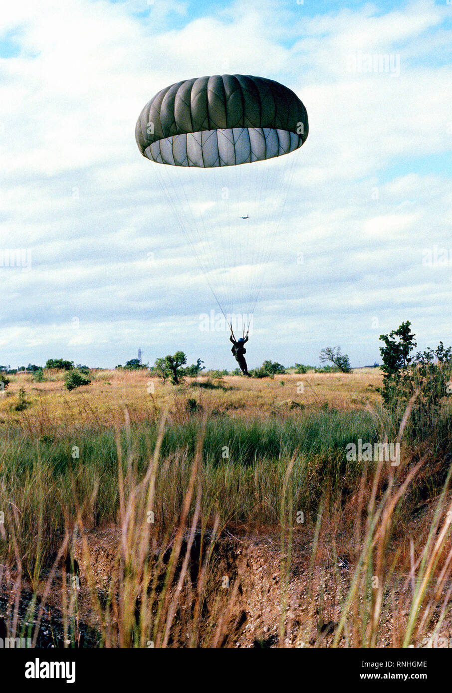 A Philippine army paratrooper lands at the drop zone during a 374th Tactical Airlift Wing airdrop. Stock Photo