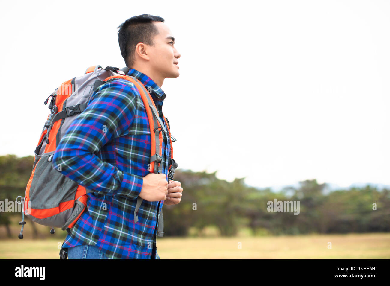 Traveler young Man with backpack looking forward Stock Photo