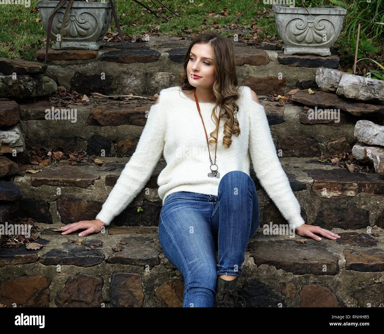 Young woman wearing a white sweater and 