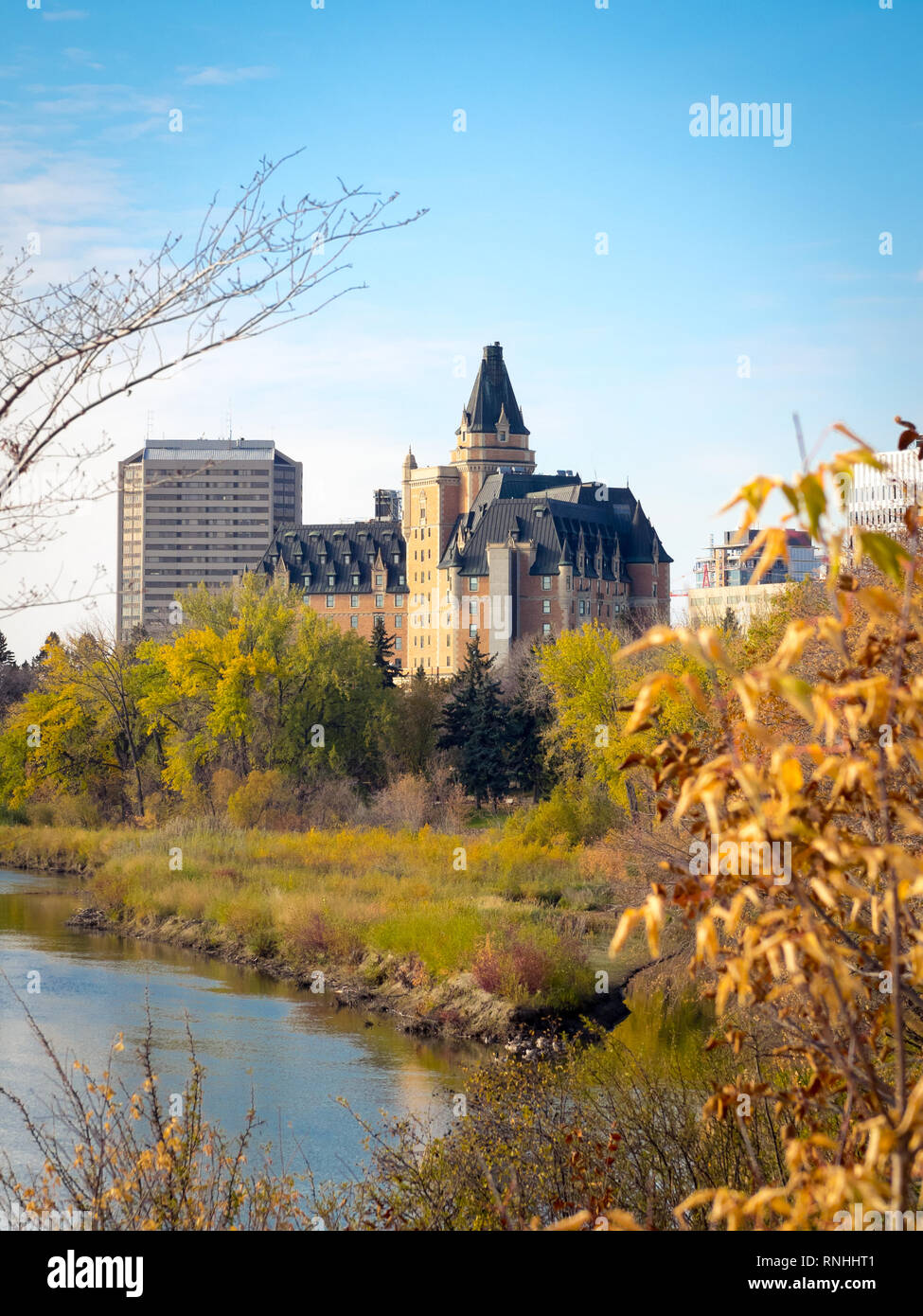 A fall view of the Delta Bessborough Hotel, South Saskatchewan River, and the skyline of Saskatoon, Saskatchewan, Canada. Stock Photo