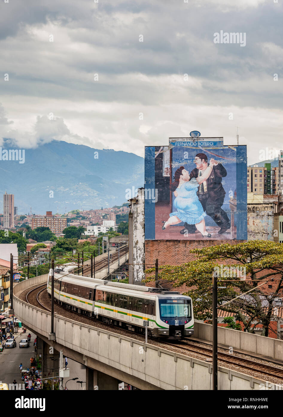 Metro Train leaving Parque Berrio Station, Fernando Botero Mural Painting, Medellin, Antioquia Department, Colombia Stock Photo