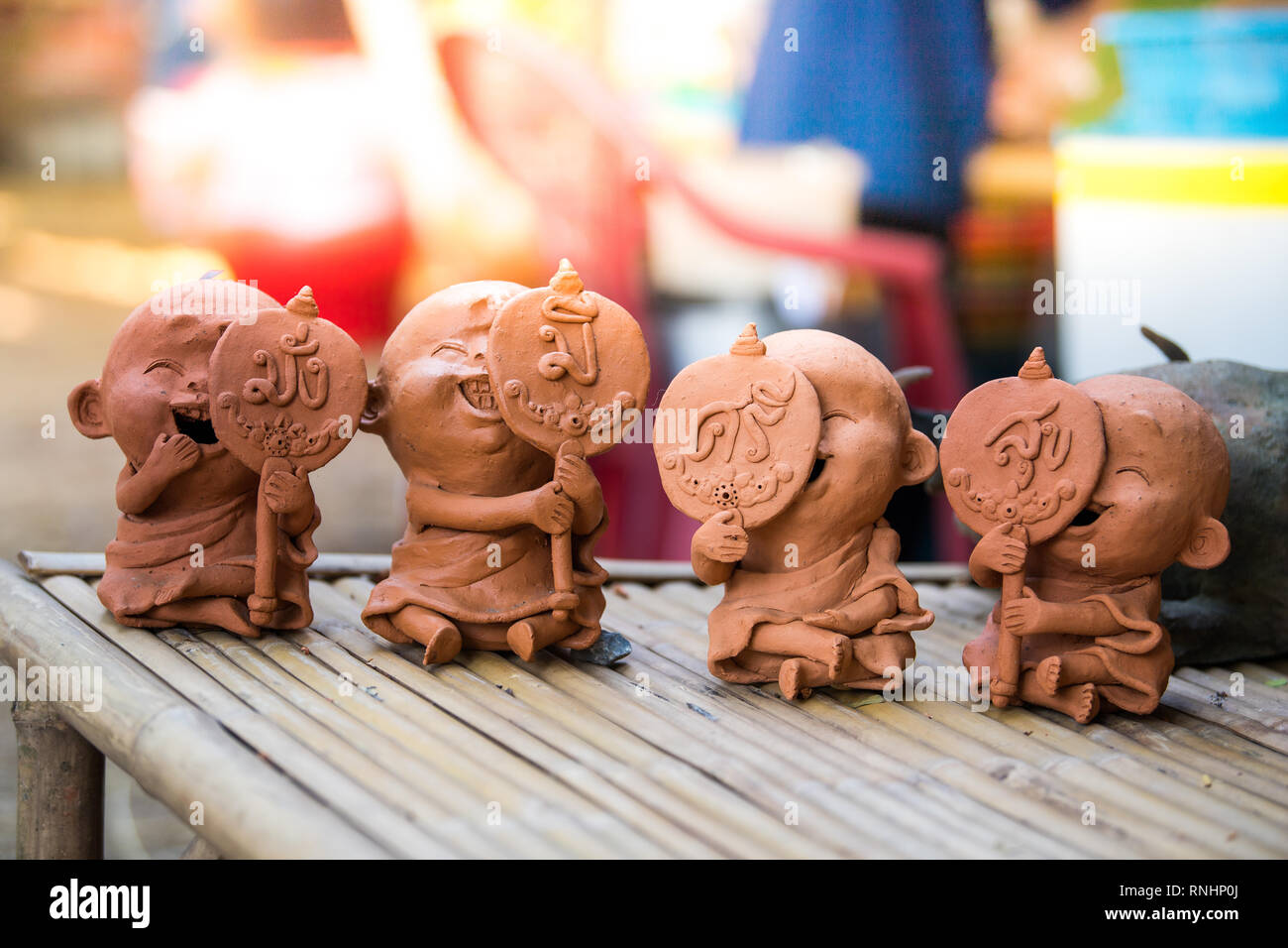 Clay doll on bamboo table. Stock Photo
